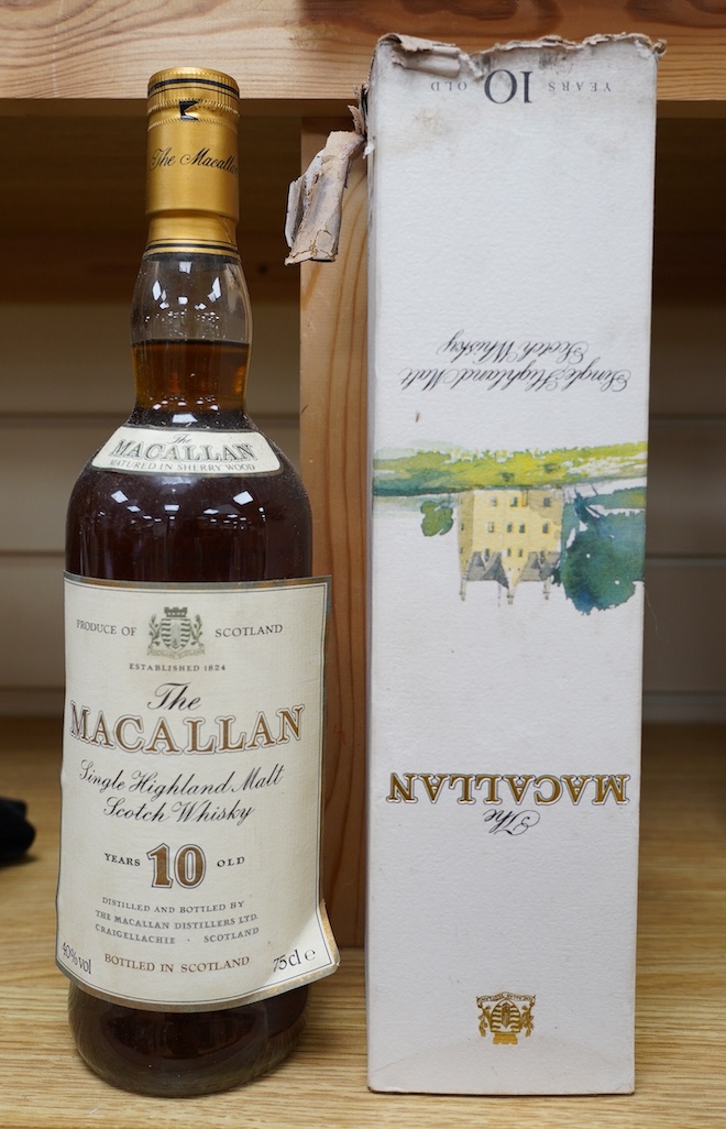 A bottle of The Macallan Single Highland Malt Scotch Whisky, 10 years old, with the remains of its original box. Condition - fair, the label on the bottle is starting to peel off and the box is in poor condition